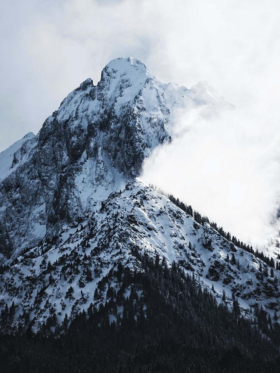 mountain range snowy mountain covered with clouds crest